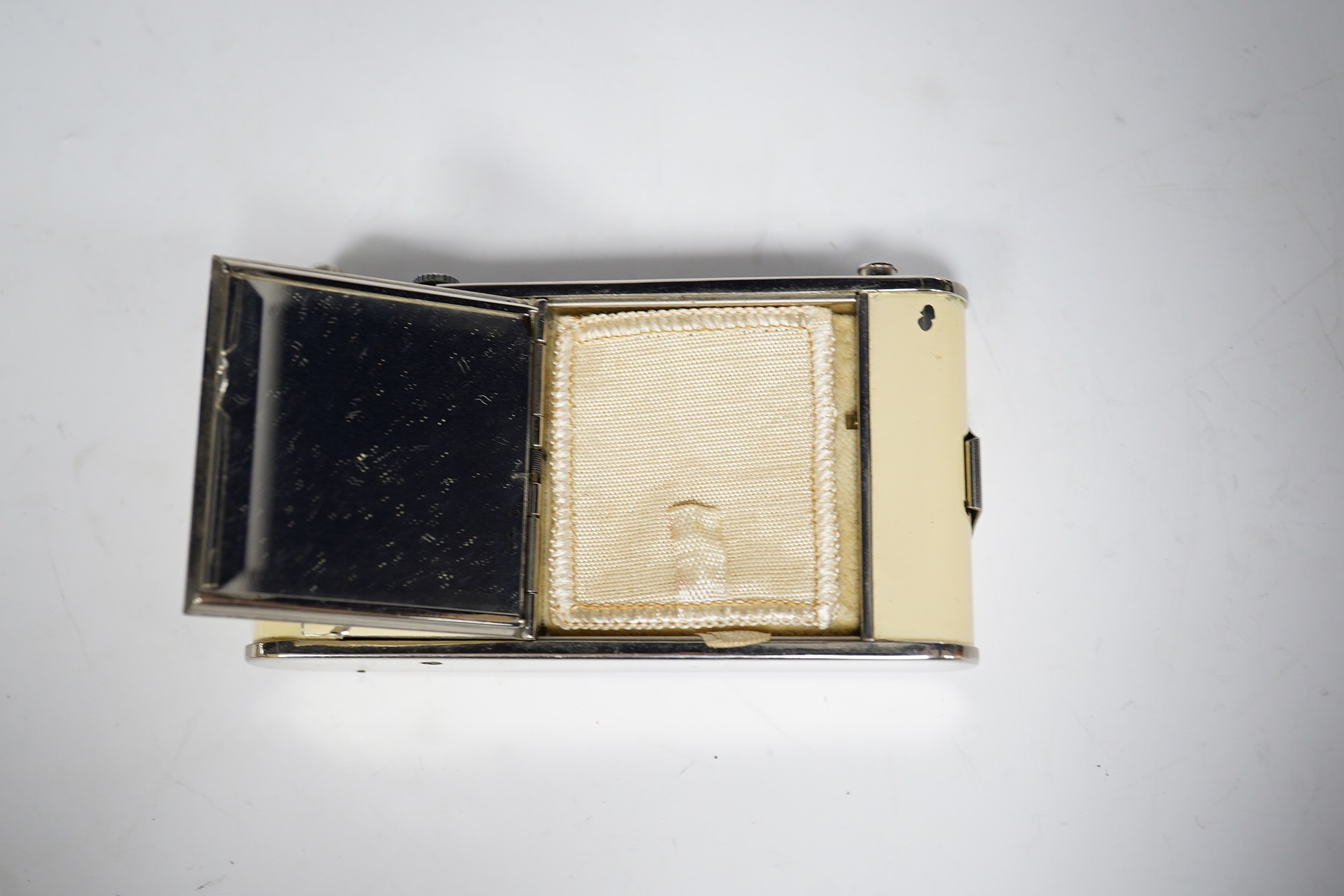 An Art Deco enamelled and chromed combined compact, a cigarette case and a timepiece, 9.5cm. Condition - minor flaking, movement going
